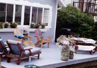 Colourful furniture can be used to tie in all the elements of the garden, including the exterior of the house