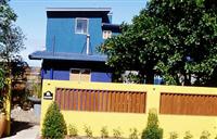 Blue building and yellow wall. Note how opposing colours create contrast. Imagine if it were a cream brick house behind a yellow wall; nowhere near the same affect.